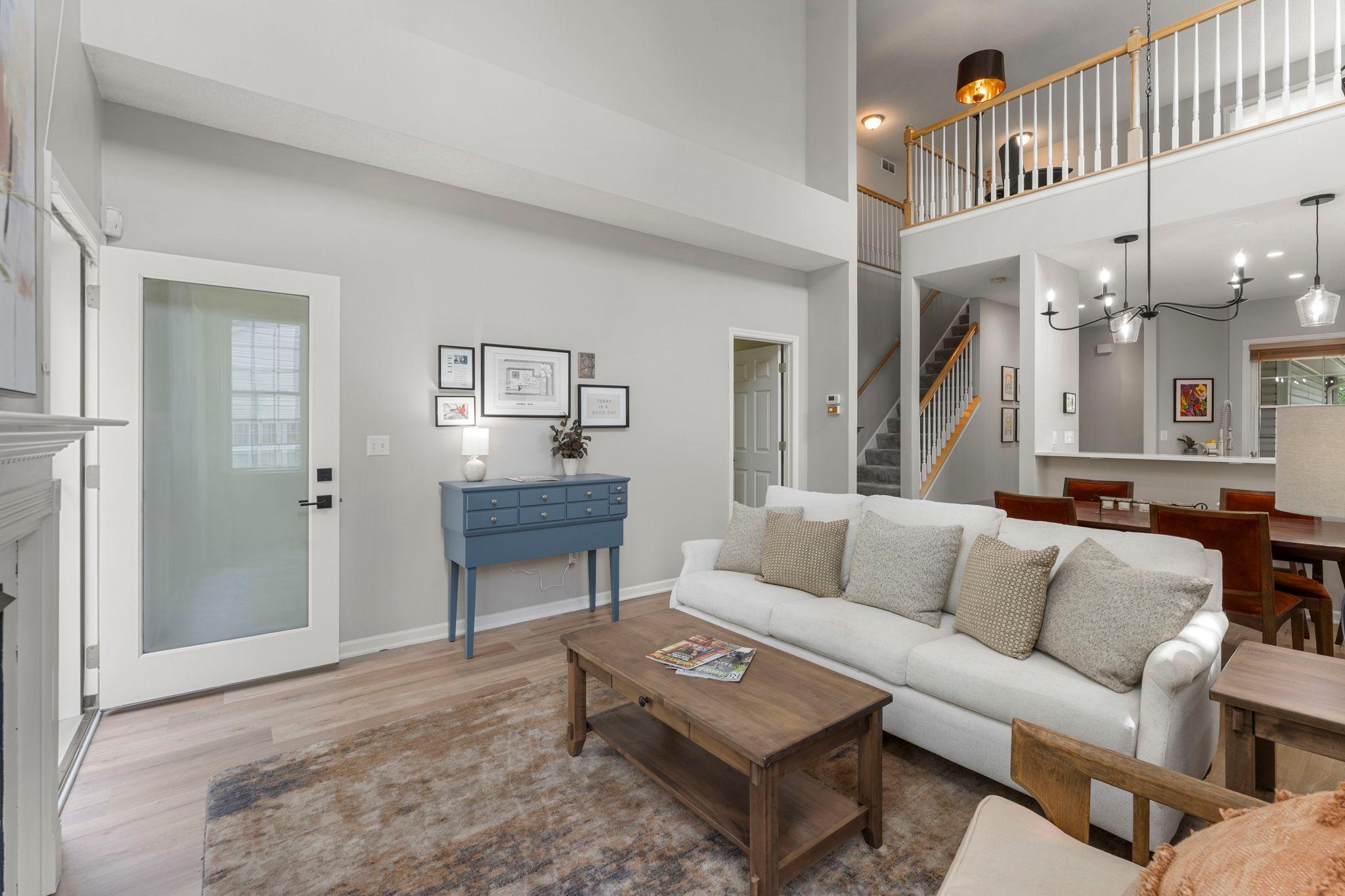 As you enter, you are greeted by a light and bright, functional layout with new luxury plank flooring seamlessly flowing throughout the main level.