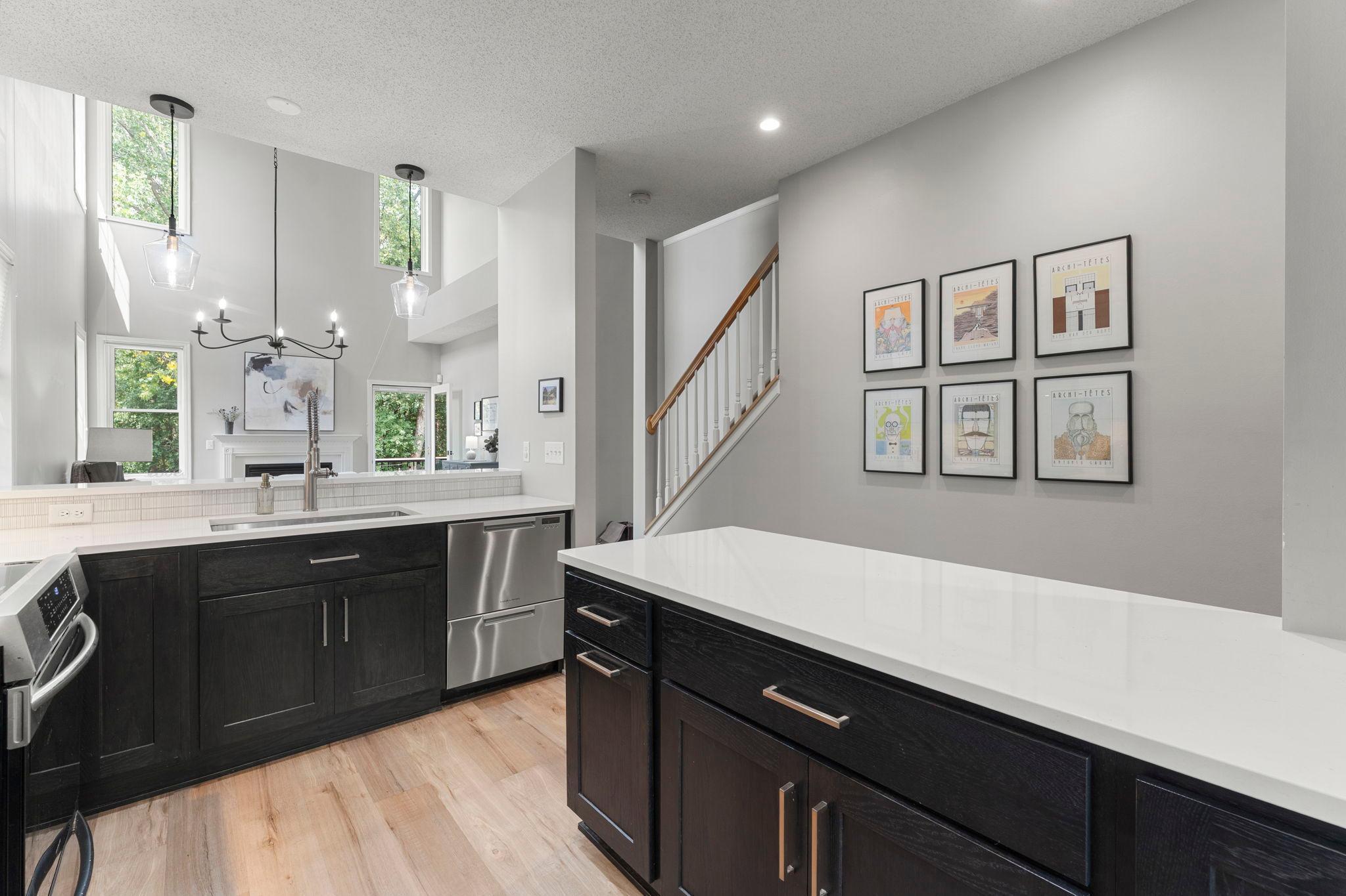 Additional highlights include a stainless steel undermount sink, under-cabinet lighting, recessed lighting, and stylish pendant lighting.