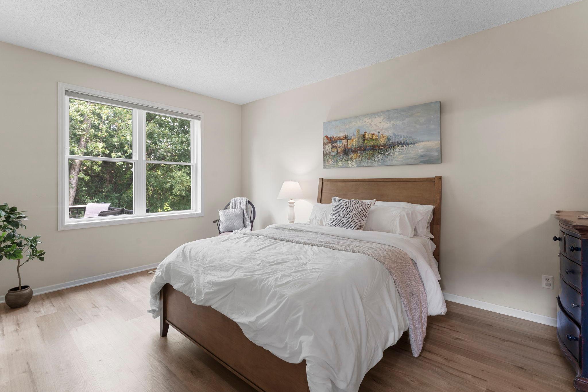 The main level offers a spacious primary suite complete with luxury plank flooring and a private full bathroom.