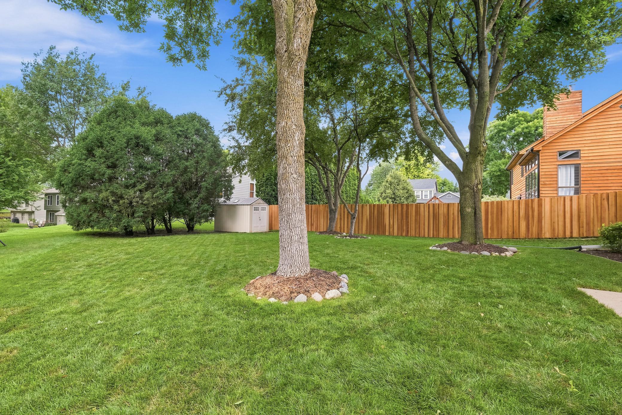 The beautifully manicured back yard offers a great space for outdoor activities and relaxing.