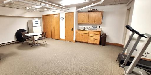 Community room with exercise equipement and a kitchnette.jpg