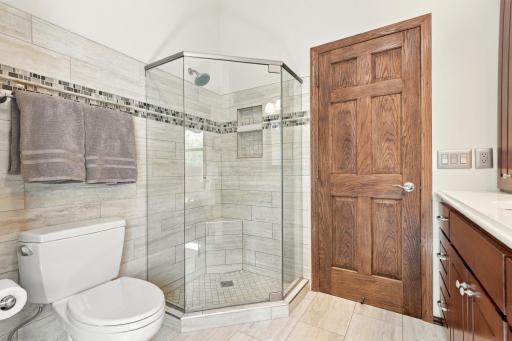 The primary bathroom has a jetted tub and tile shower.