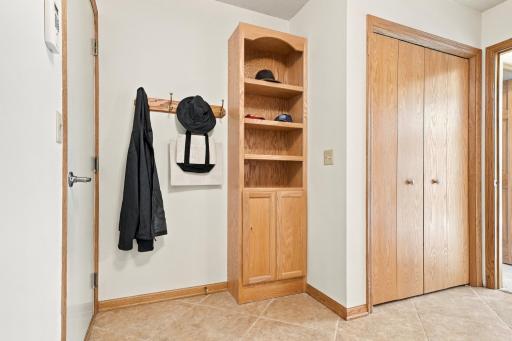 There is storage and closet space at the garage entrance to the home.