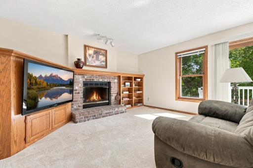 The family room has built in cabinetry and a wood burning fireplace.