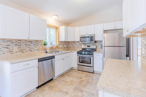 Cute, clean, and functional kitchen with plenty of prep space (no AI)