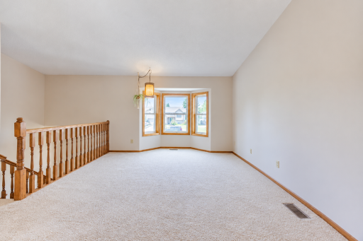 Living room upstairs. Cute bay window and vaulted ceilings really make the space feel light and airy. Brand new carpeting as of 9/24!