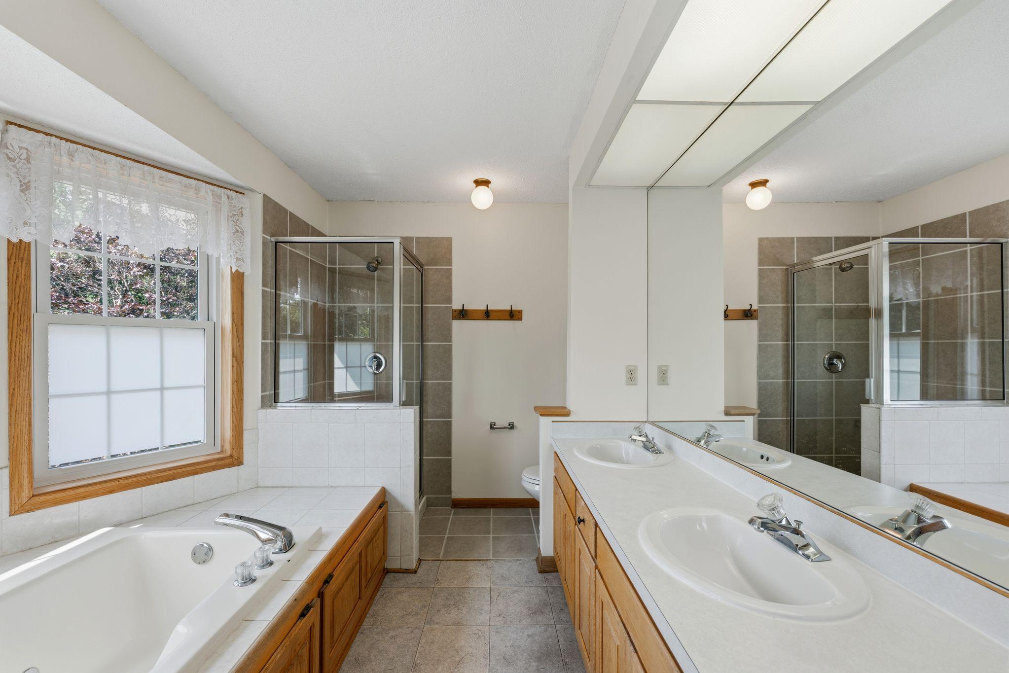 Primary bedroom private bath; separate shower and tub