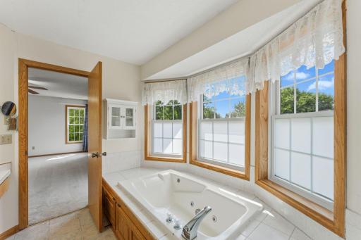 Enjoy a private ensuite featuring a relaxing whirlpool tub and pleanty of light.