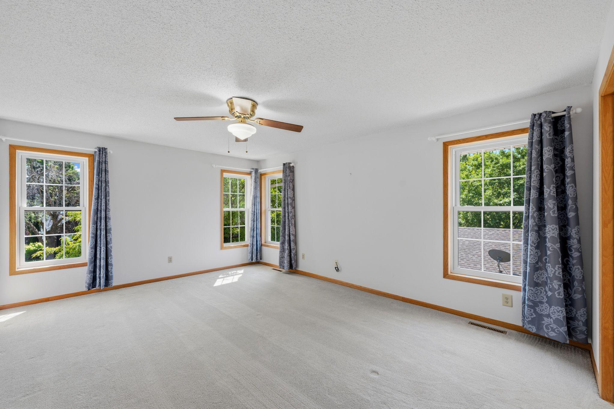 A spacious owner's retreat with room for oversized furniture and a sitting area.