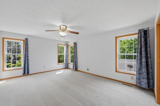 A spacious owner's retreat with room for oversized furniture and a sitting area.