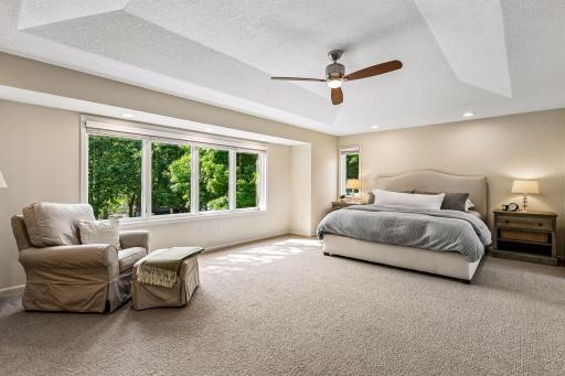 Upstairs, the luxurious primary suite offers a private office with sliding doors, oversized walk-in closet with laundry, and spa-inspired bathroom featuring a soaking tub and walk-in shower.