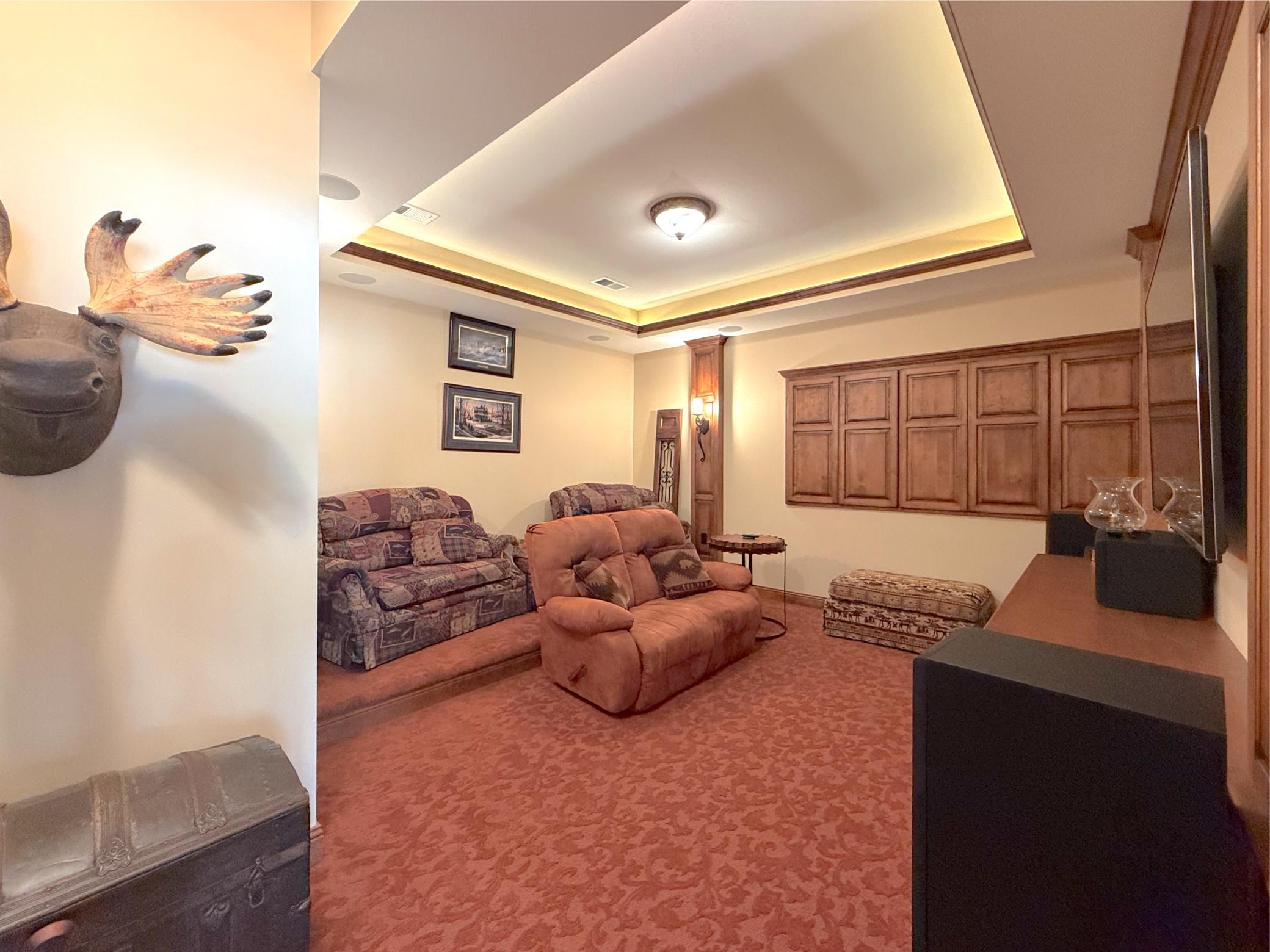 This spacious media room offers the perfect retreat for relaxing with family and friends while enjoying your favorite films and sporting events.