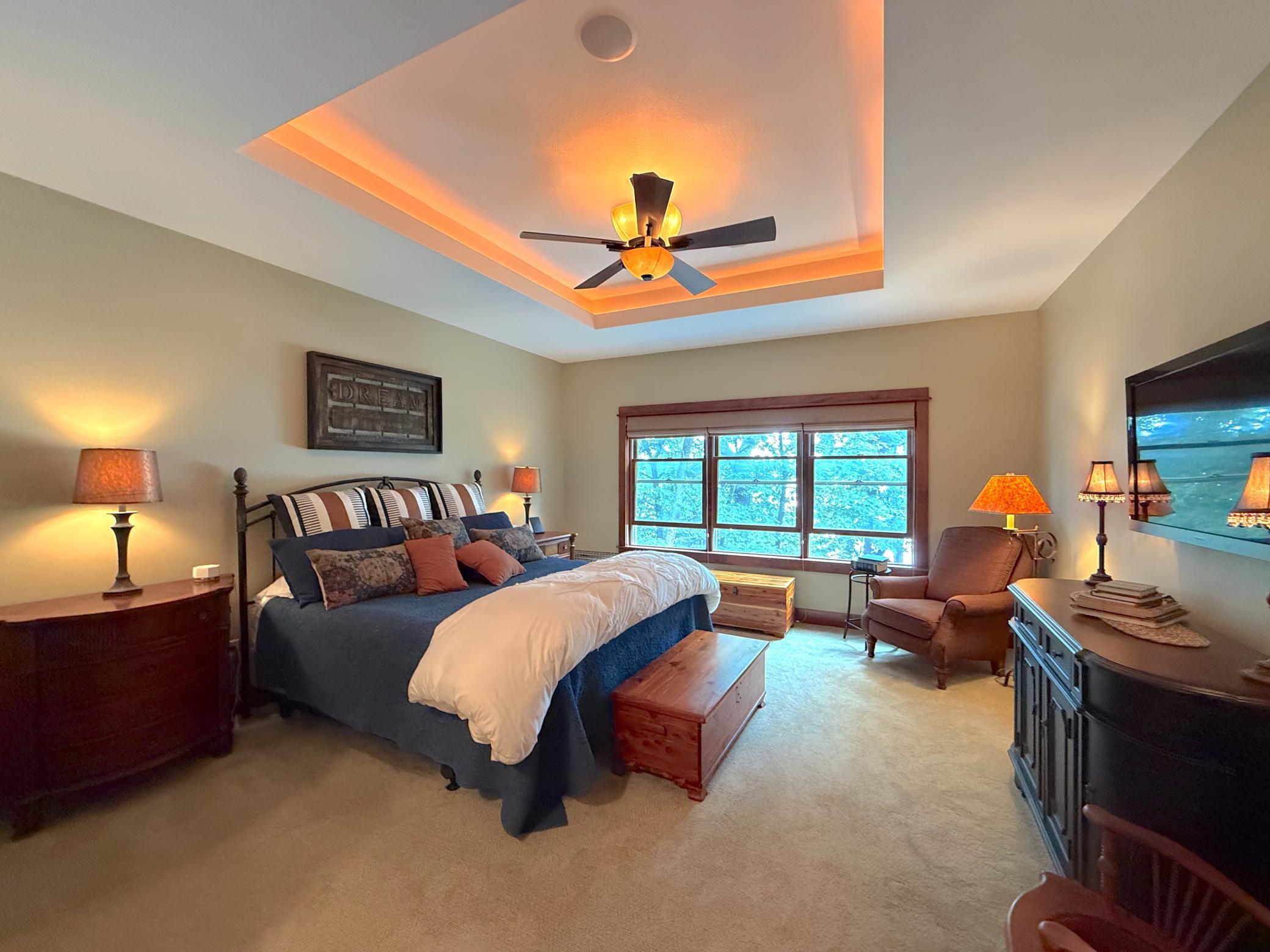 This luxurious primary bedroom offers generous proportions, elegant finishes, and a serene atmosphere perfect for unwinding at the end of the day.