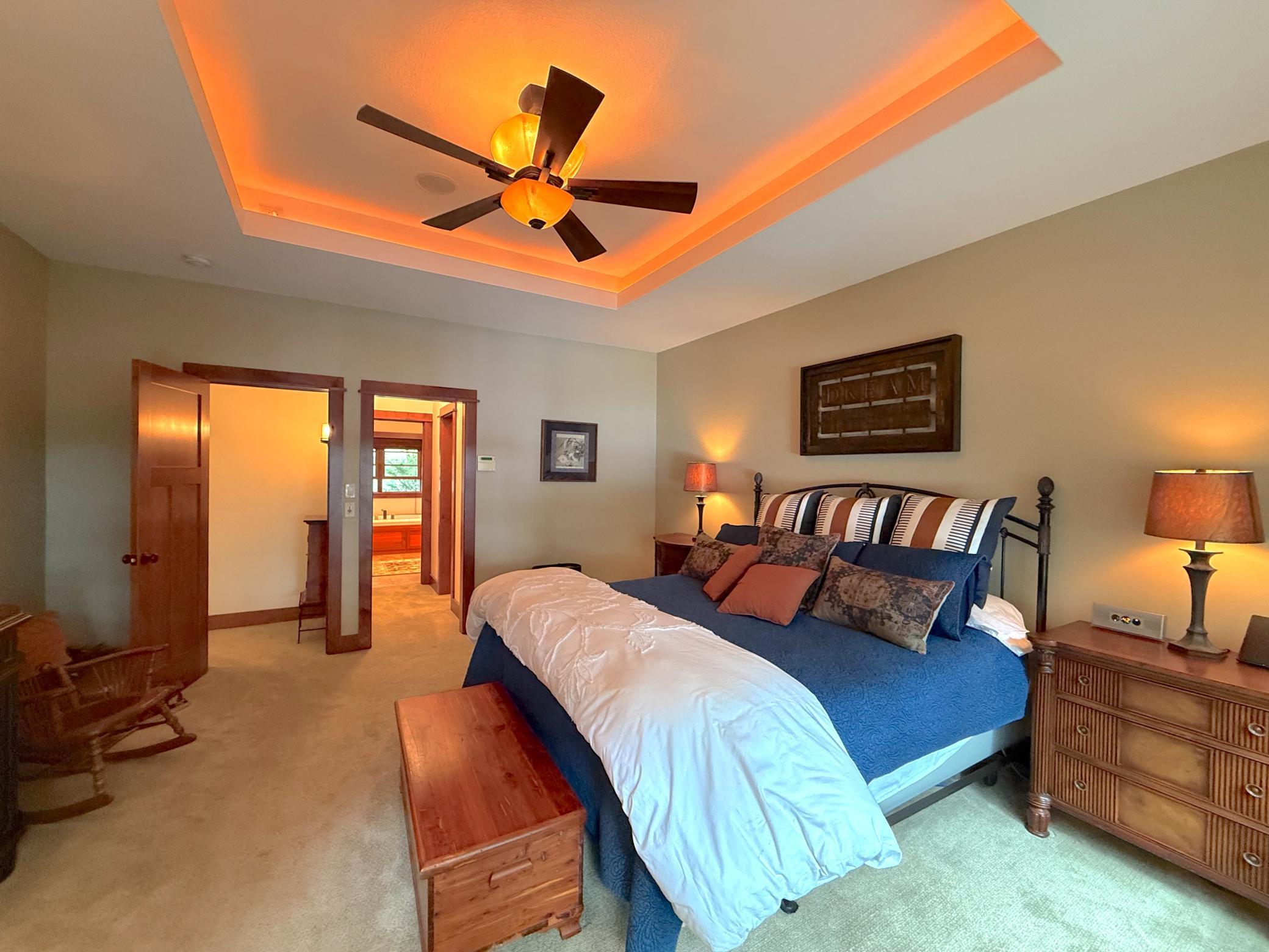 The expansive owner's suite combines comfort and sophistication with a stunning tray ceiling and beautiful views of the surrounding landscape.