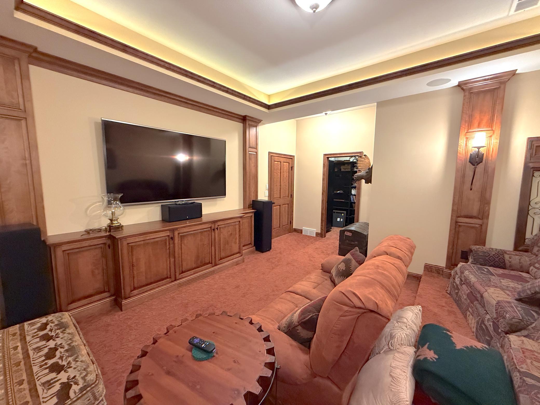 The finished lower-level media room provides a private space for entertainment, recreation, or a quiet evening at home.