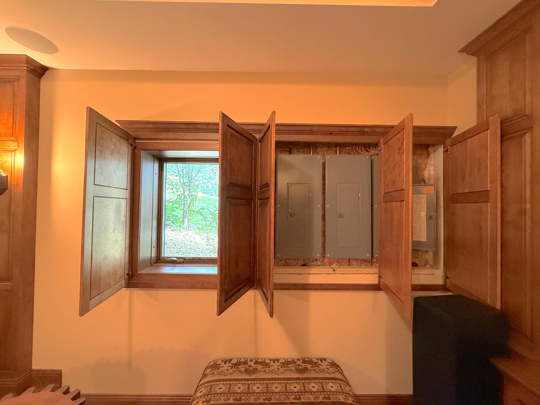 Hidden custom cabinetry discreetly conceals the home's electrical panels, showcasing the exceptional attention to detail and craftsmanship found throughout.