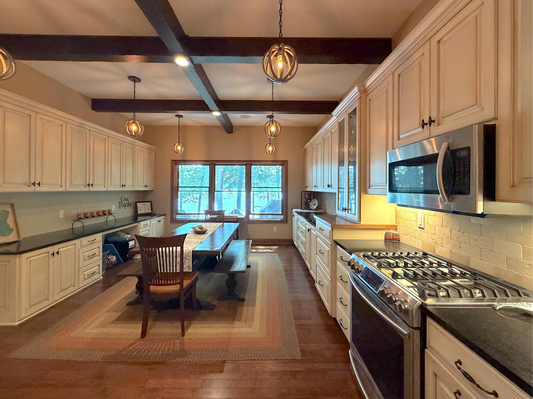 Thoughtfully designed with custom cabinetry, stainless steel appliances, and lake views, this spacious lower-level kitchen adds exceptional versatility to the home.