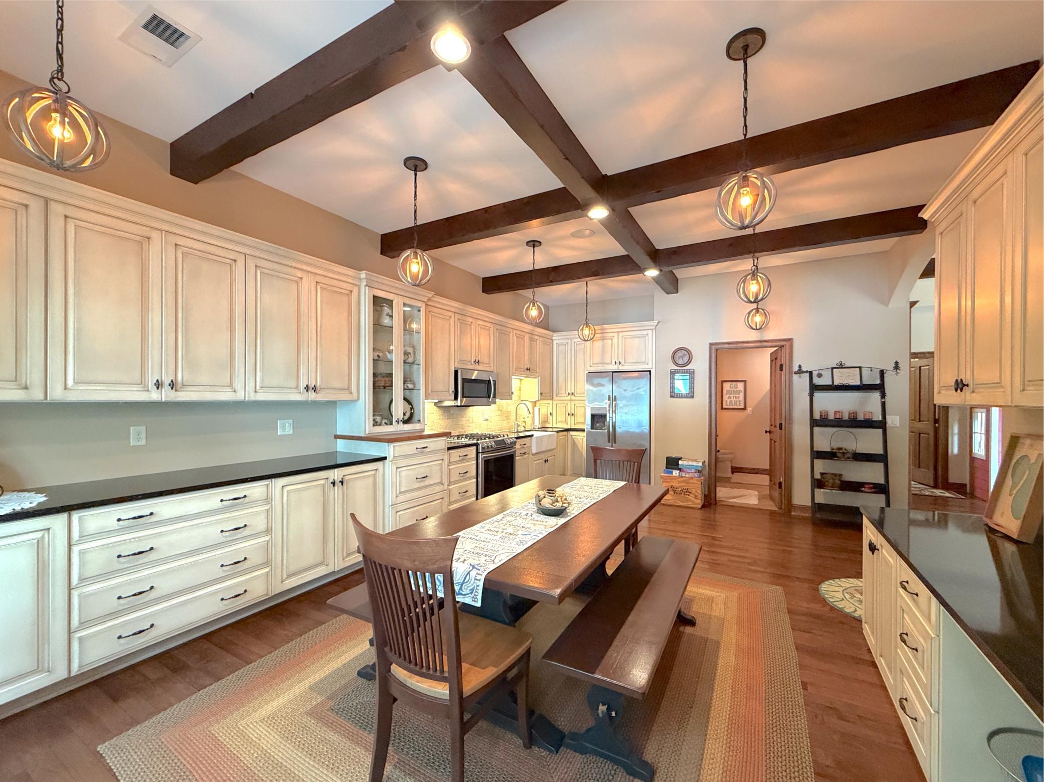 This impressive lower-level kitchen and dining area provides a functional and inviting space for guests to gather after a day on the lake.