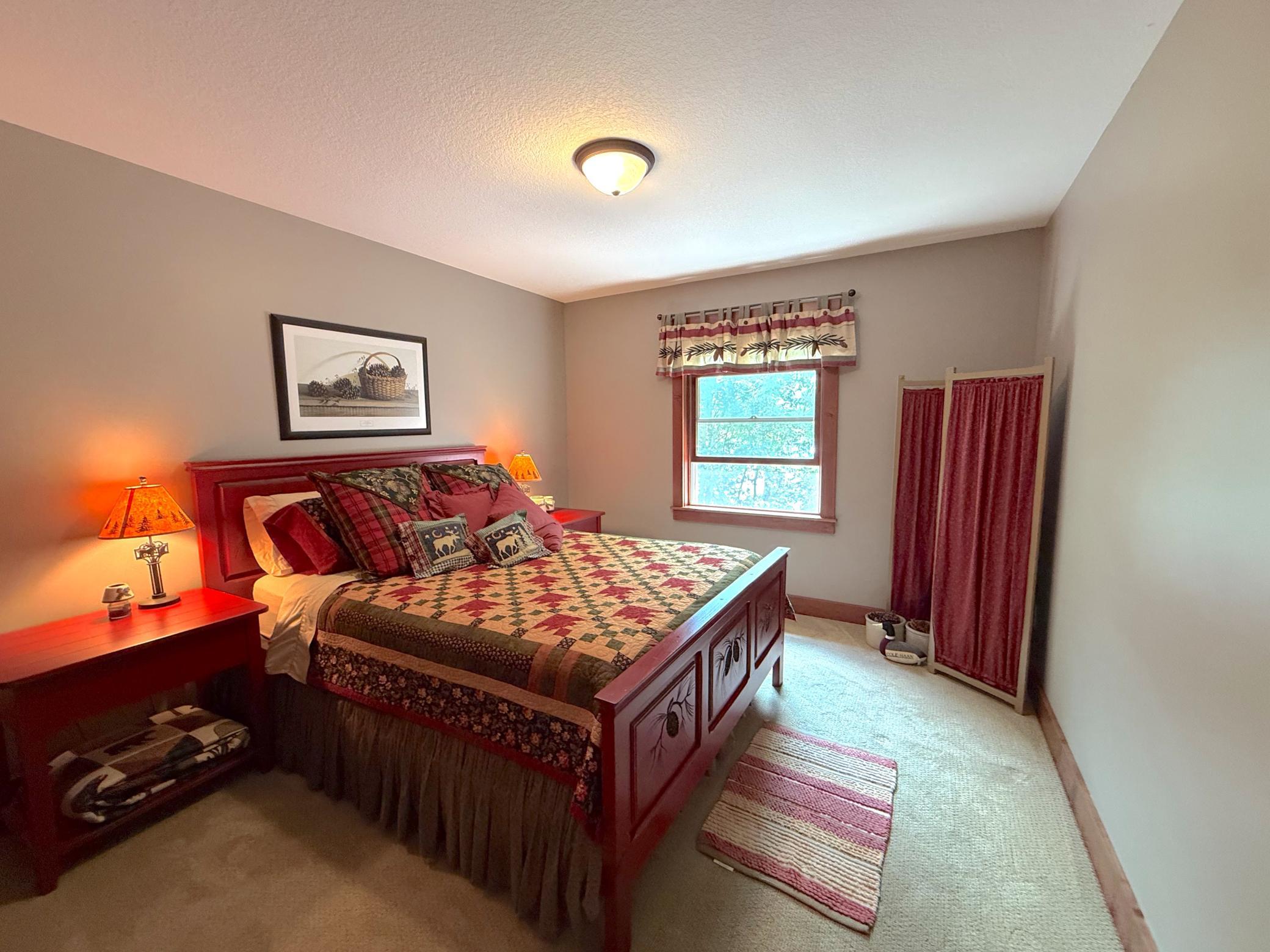 This comfortable upper-level bedroom offers a peaceful retreat with warm finishes and abundant natural light.