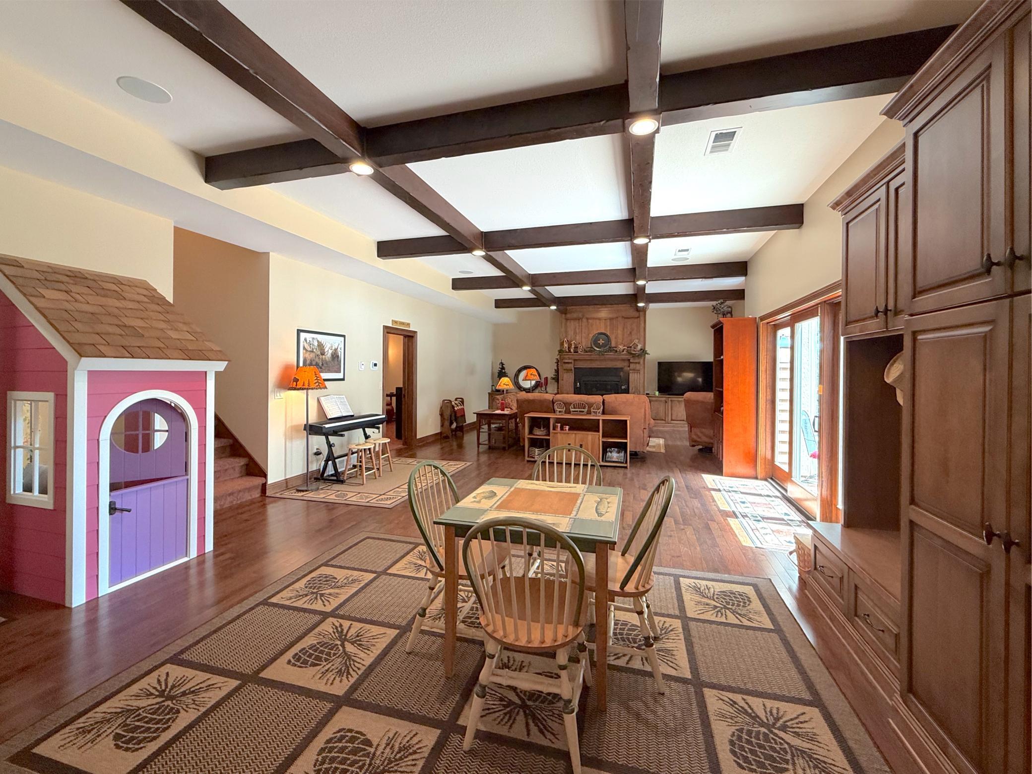 A charming under-stair playhouse creates a magical retreat for children, adding a unique and whimsical touch to the lower level.