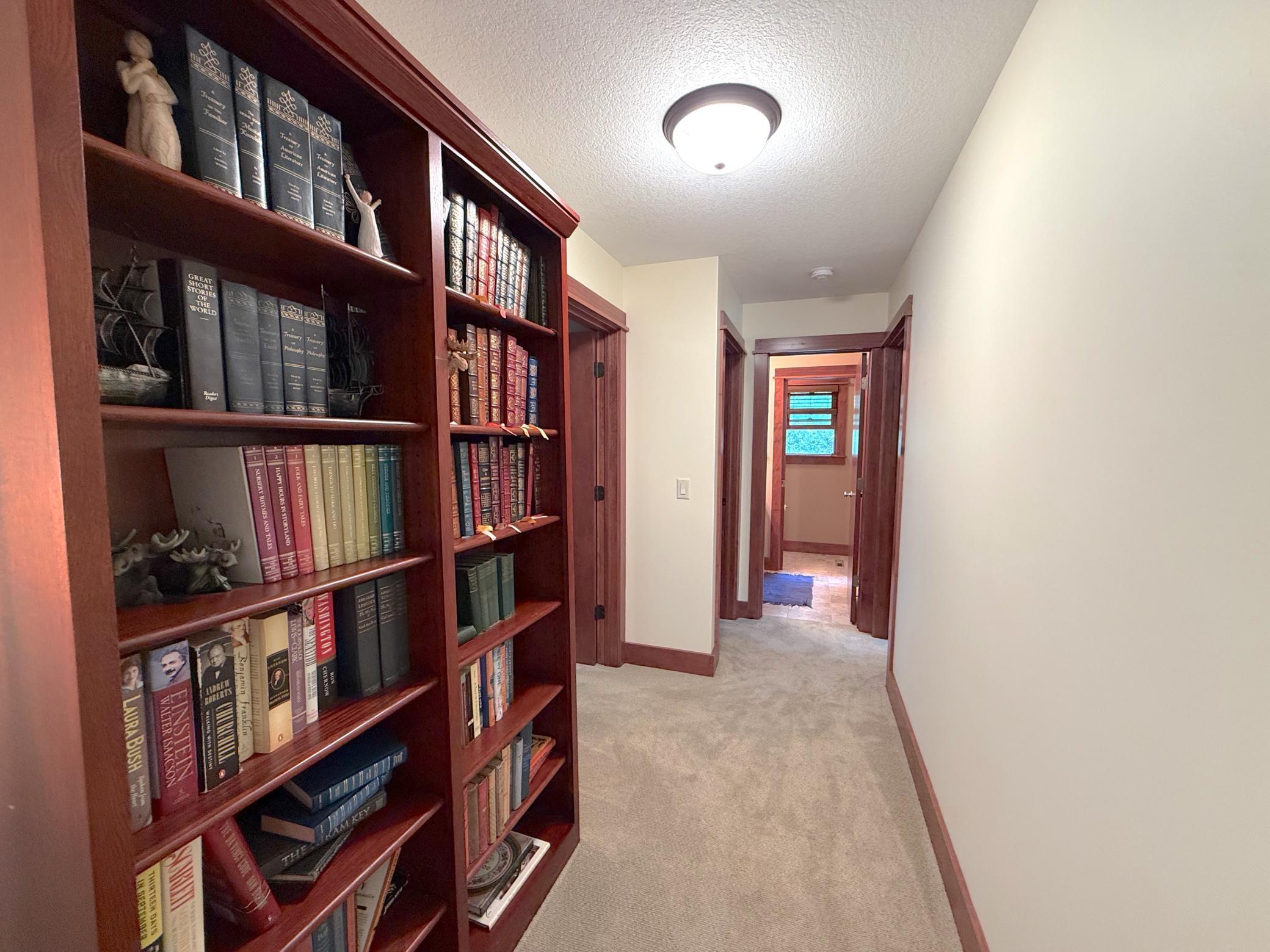 The upper level offers a warm and inviting transition between bedrooms, highlighted by rich wood finishes and thoughtful design details.