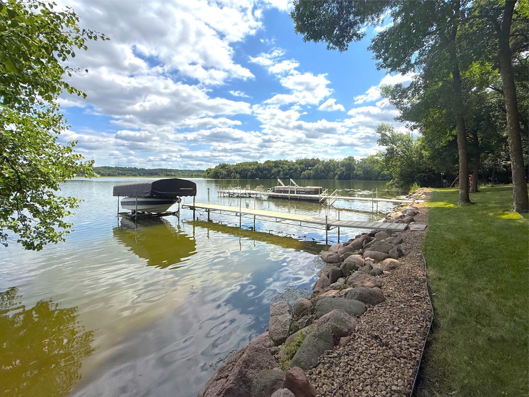 Enjoy beautiful Lake Louisa from your private dock, surrounded by a peaceful shoreline, mature trees, and a gently landscaped lakeside setting perfect for relaxing or spending the day on the water.