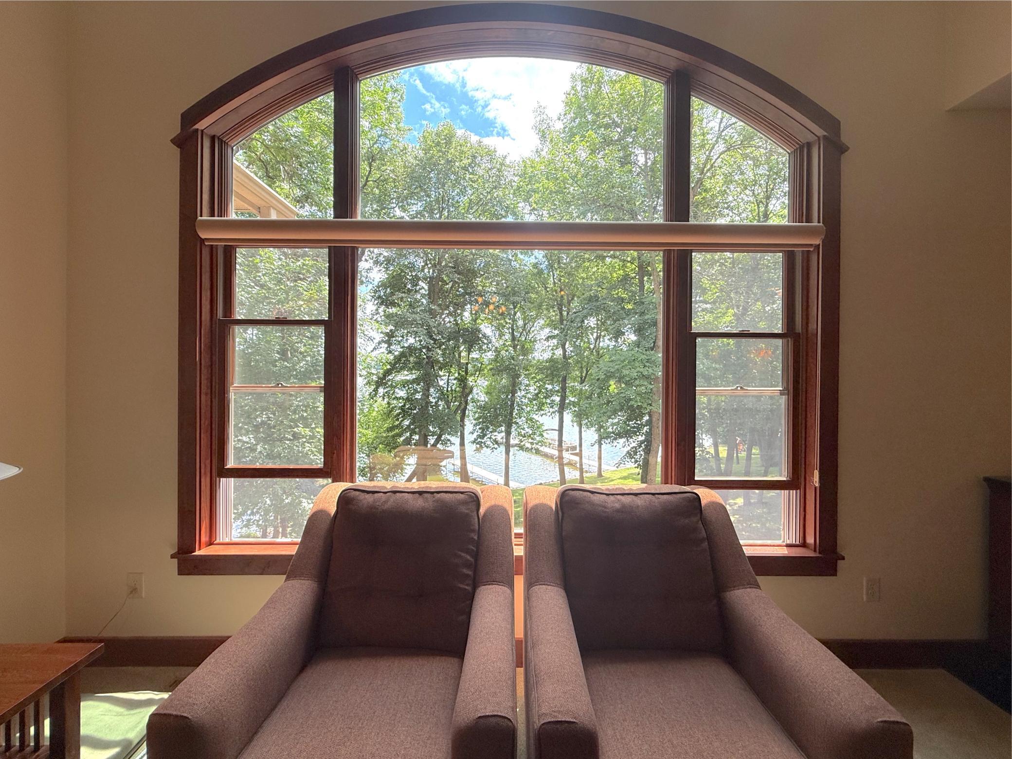 Enjoy tranquil lake views framed by a stunning arched picture window that fills the home with natural light.