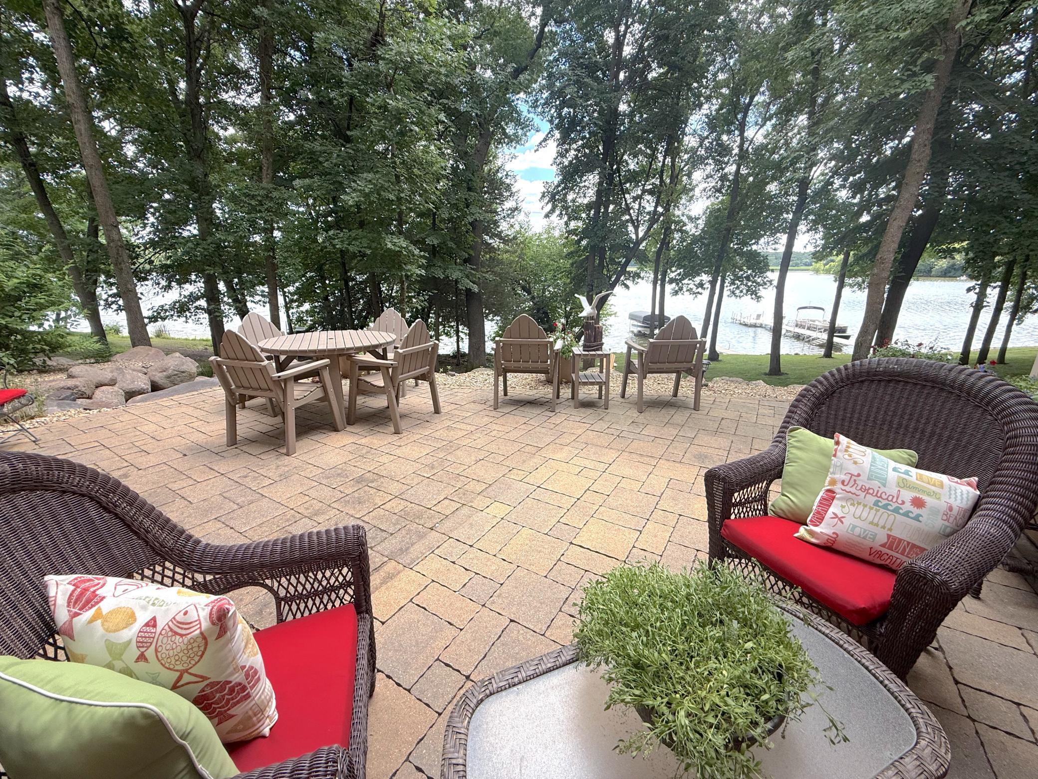 This beautifully designed paver patio provides an exceptional outdoor living experience, complete with peaceful lake views and mature trees for added privacy.