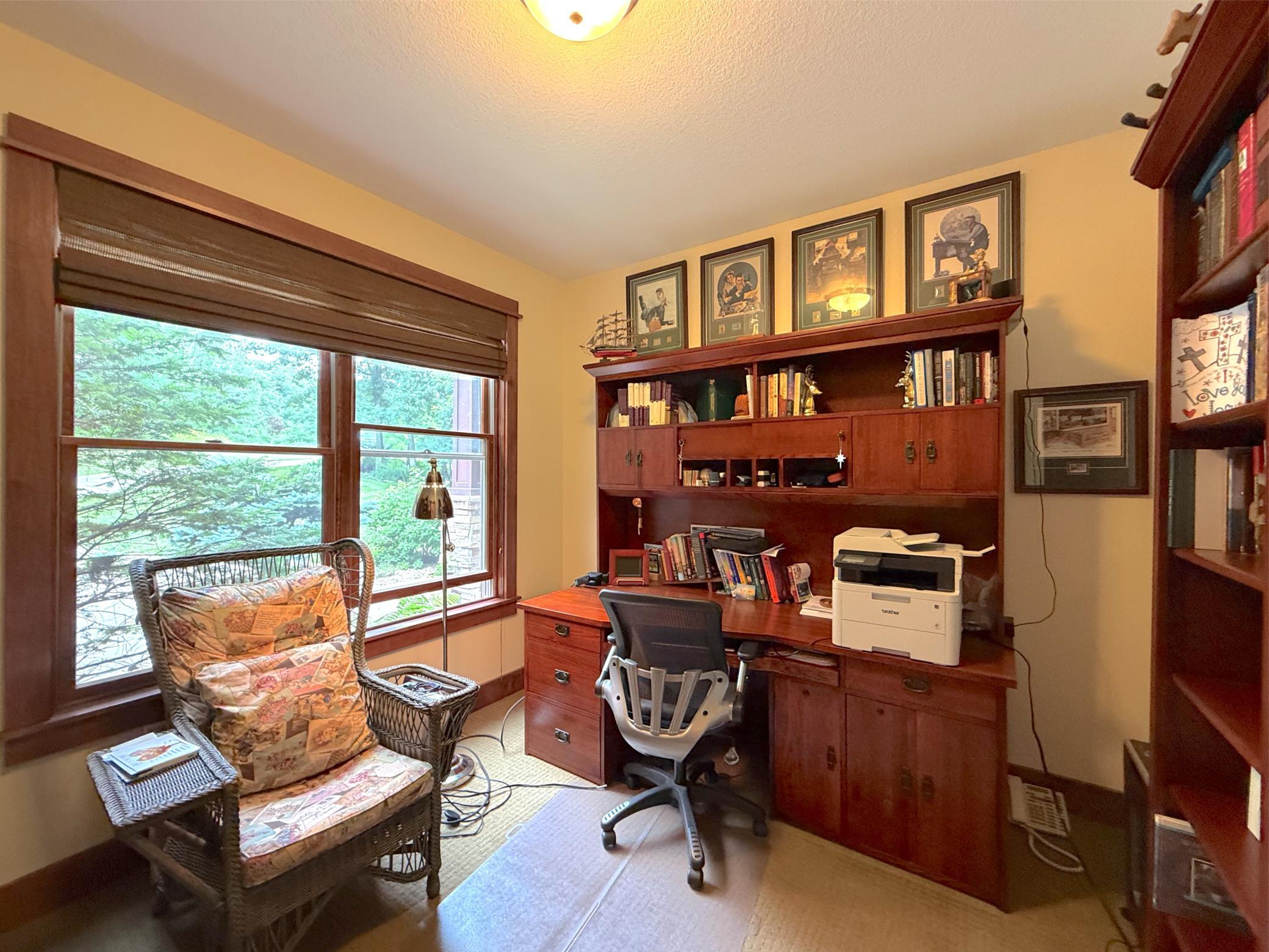 This versatile home office offers a quiet and comfortable workspace with custom built-ins and abundant natural light.