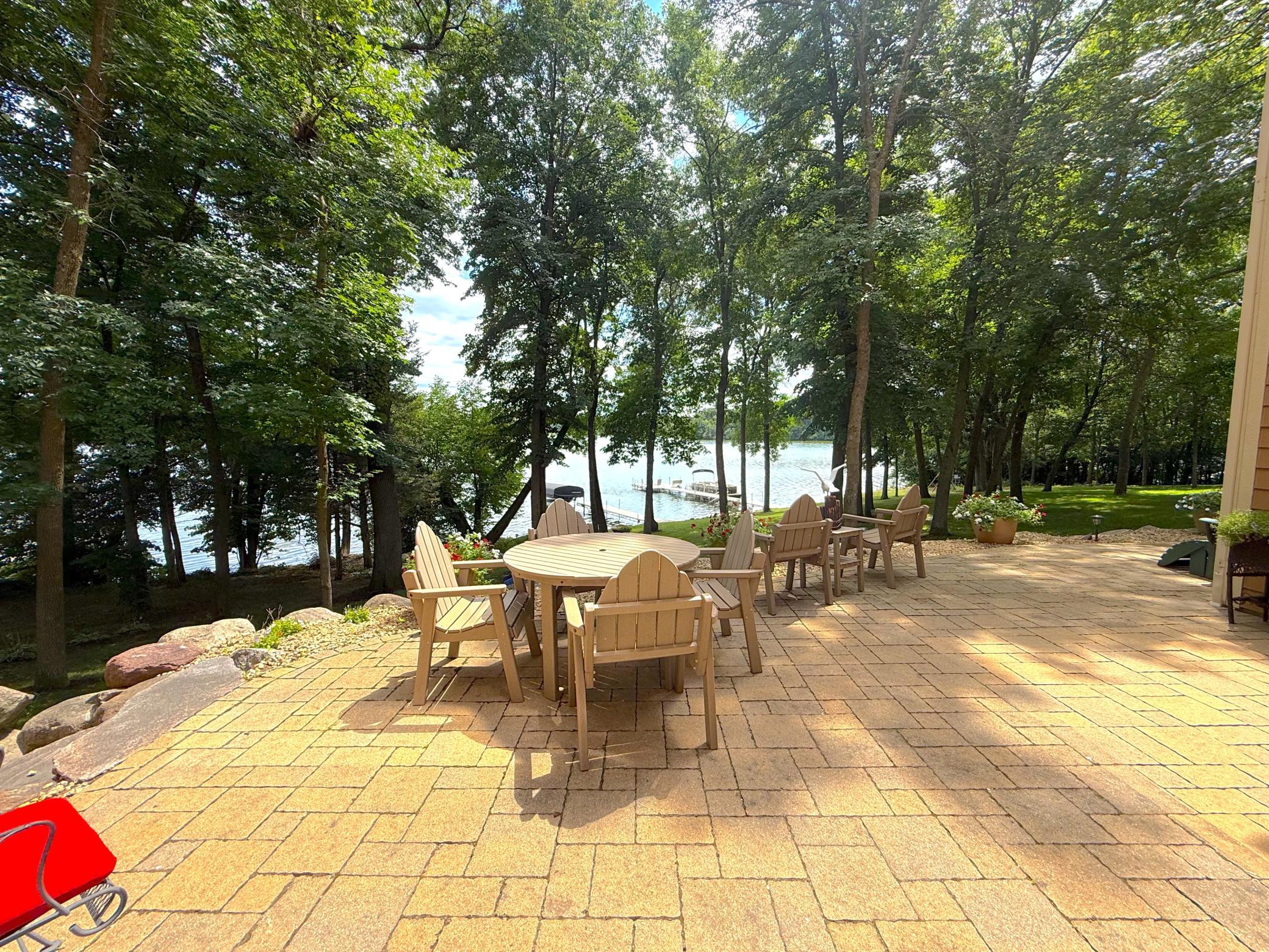 Entertain with ease on the expansive lakeside patio, where multiple seating areas offer the perfect setting for dining, relaxing, and enjoying the view.