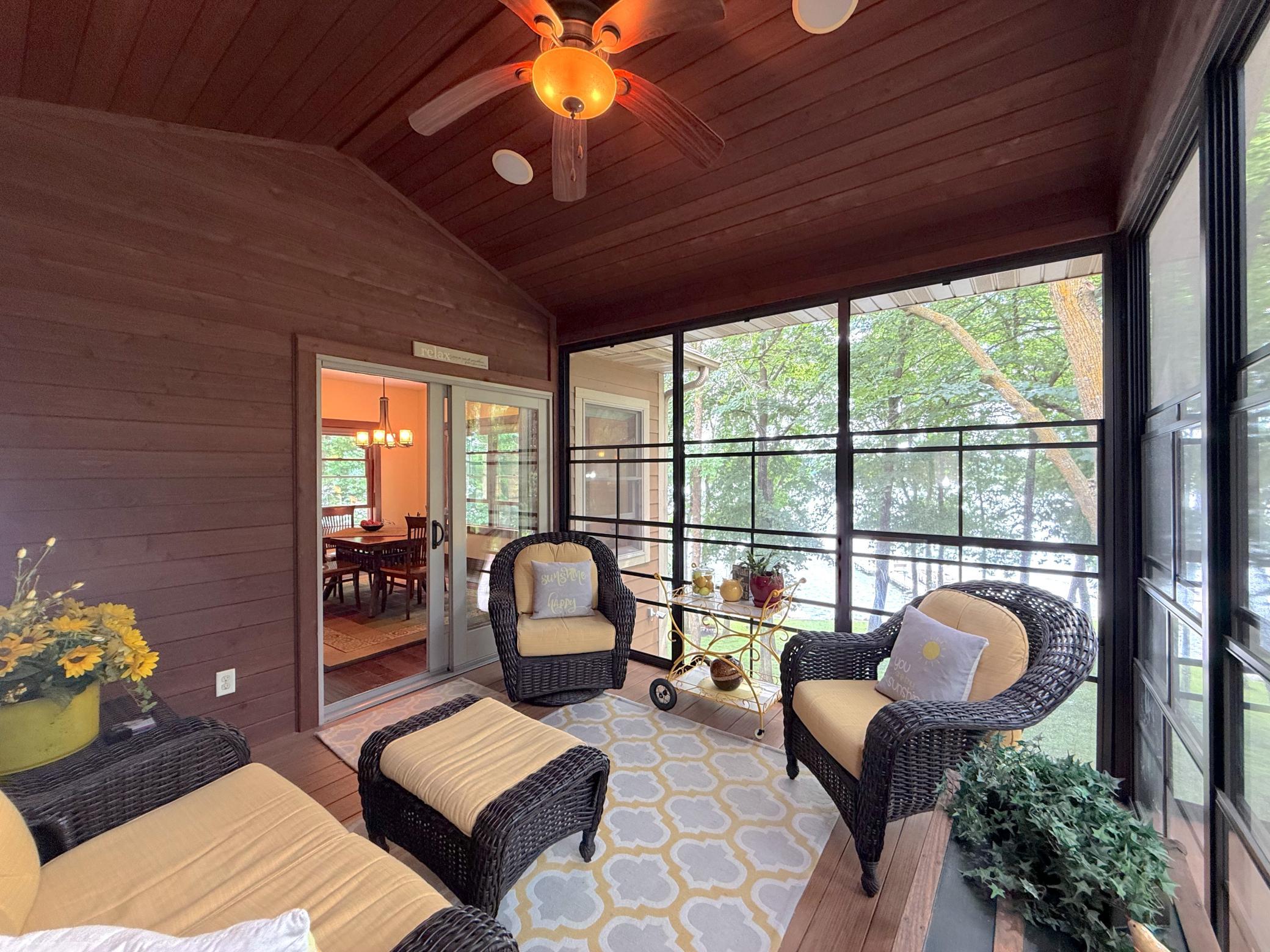 the beauty of the surrounding landscape.
Surrounded by nature and abundant fresh air, this charming screened porch seamlessly extends your living space outdoors.