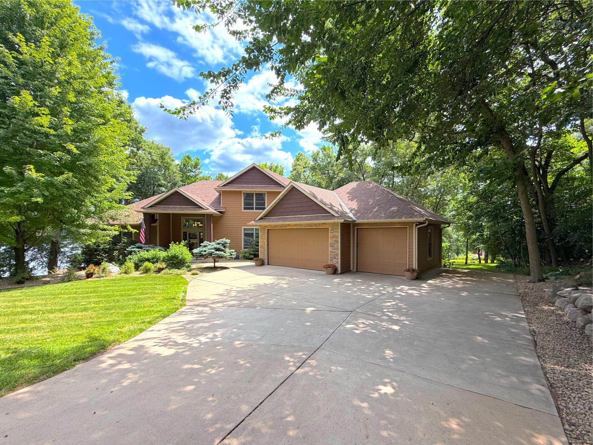 This impressive four-bedroom, four-bathroom home is designed for both everyday comfort and memorable gatherings set on Lake Louisa.