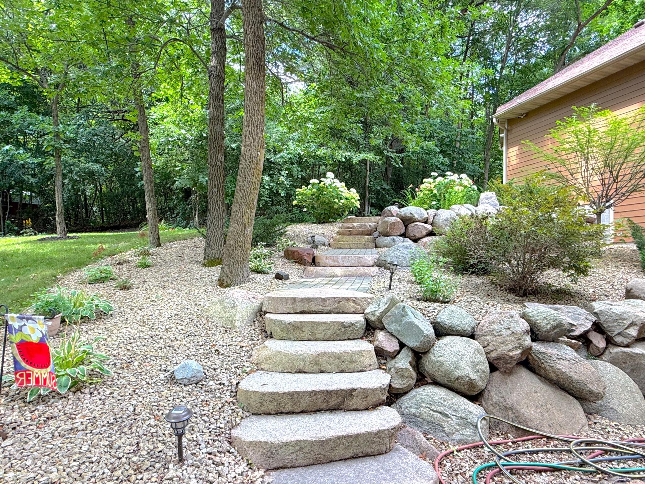 Exceptional stonework and terraced landscaping enhance the natural beauty of the grounds while adding timeless curb appeal.
