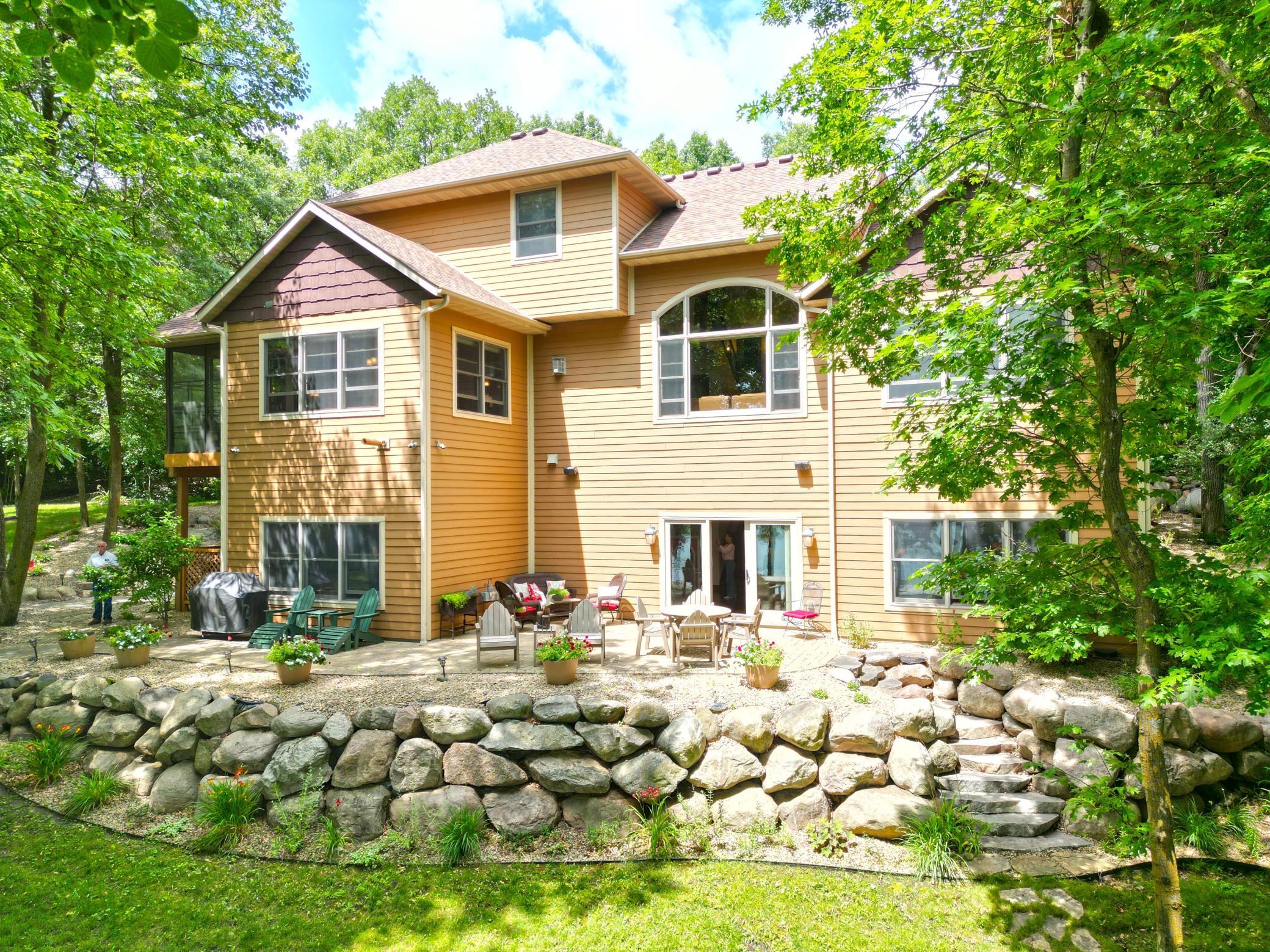 The park-like setting is simply exceptional. Professionally designed landscaping surrounds the home with winding paver walkways, colorful perennial gardens and impressive boulder accents.