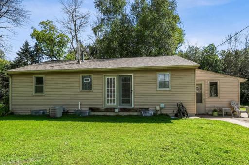 Well-kept exterior with French doors opening to the backyard, level lawn, and space for entertaining or adding a deck.