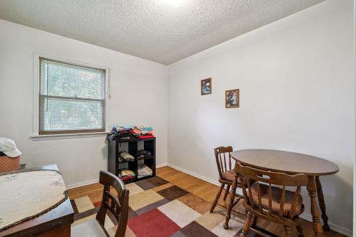 Versatile third bedroom or flex space with hardwood flooring, ideal for use as a guest room, office, or hobby space.