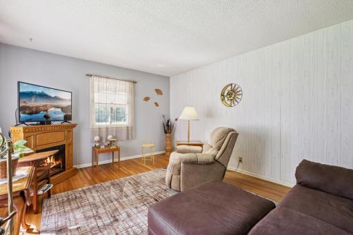 Second view of the living area with charming details, hardwood flooring, and versatile wall space for dÃ©cor.