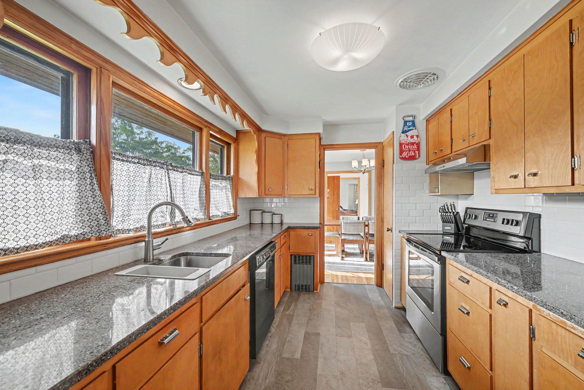 Kitchen with quartz countertops and wood cabinetry at 300 5th Street NE, Montgomery, MN.