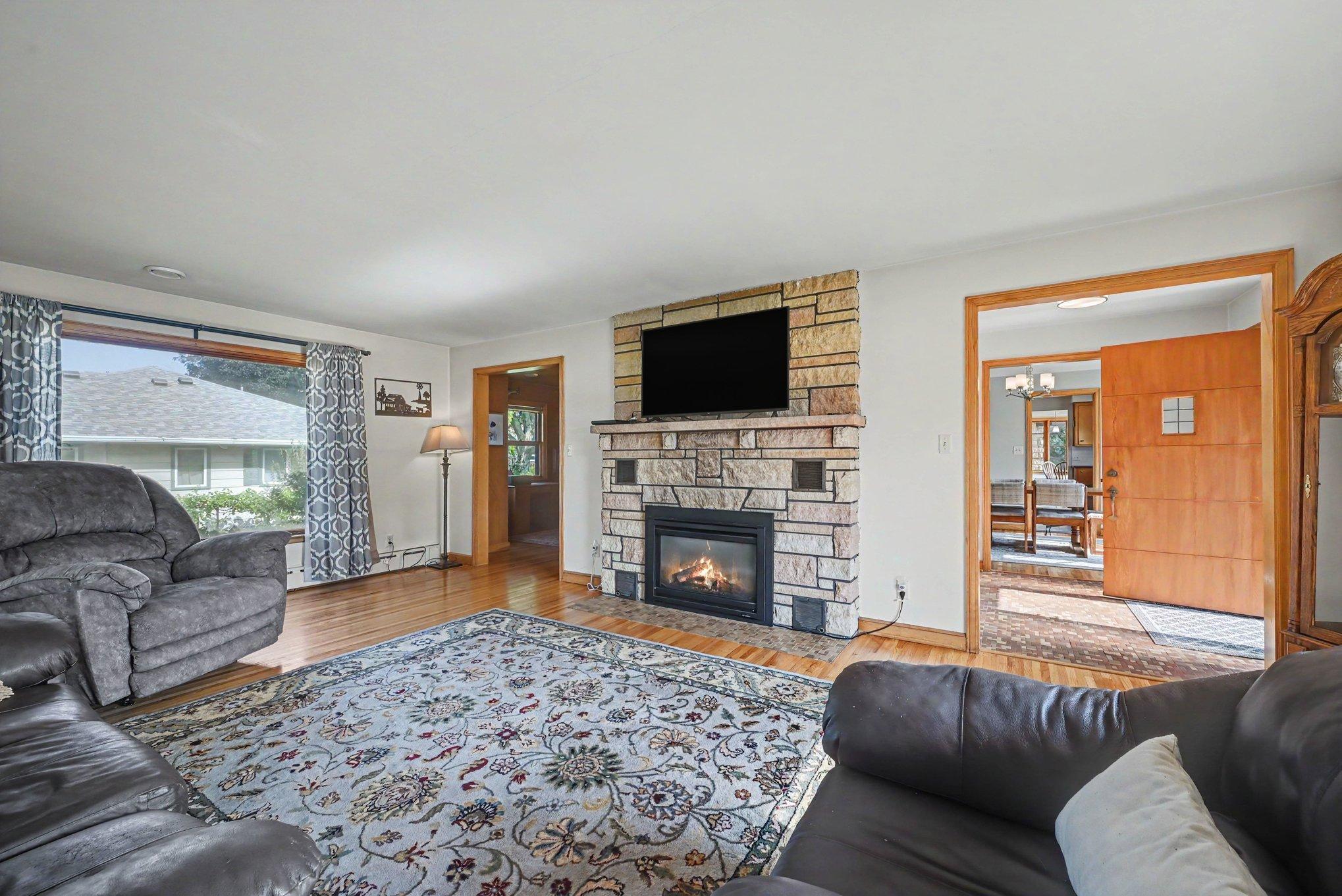 Main floor living room with stone gas fireplace and hardwood floors, Montgomery MN home for sale.
