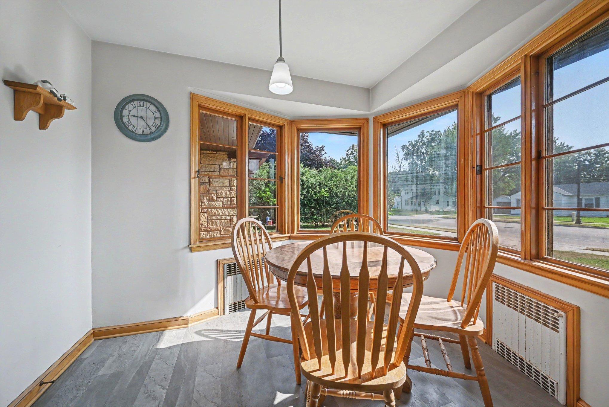 Rounded informal dining nook wrapped in windows, 1950 rambler in Montgomery, MN.