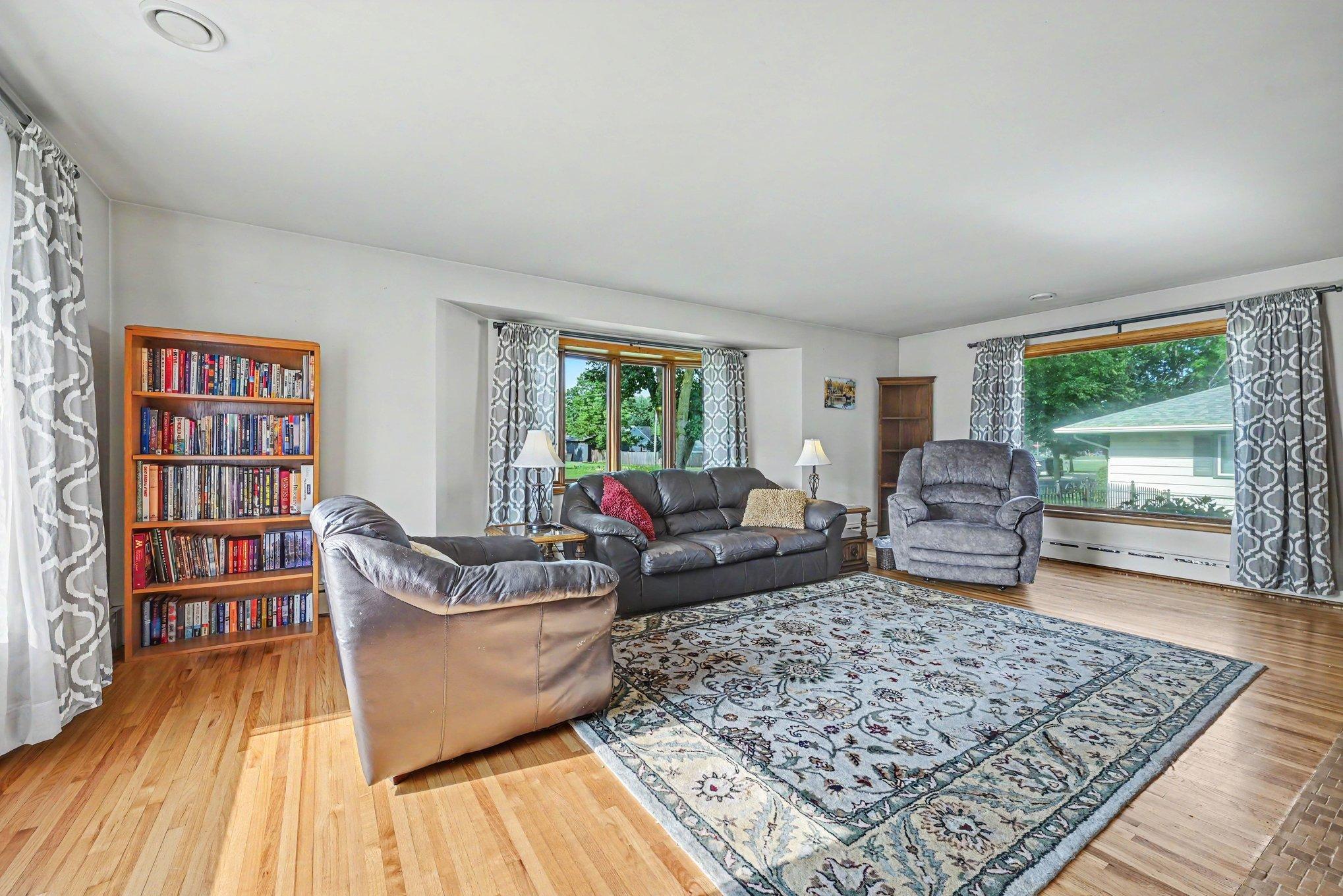 Living room with hardwood floors and large picture windows, Montgomery MN rambler.