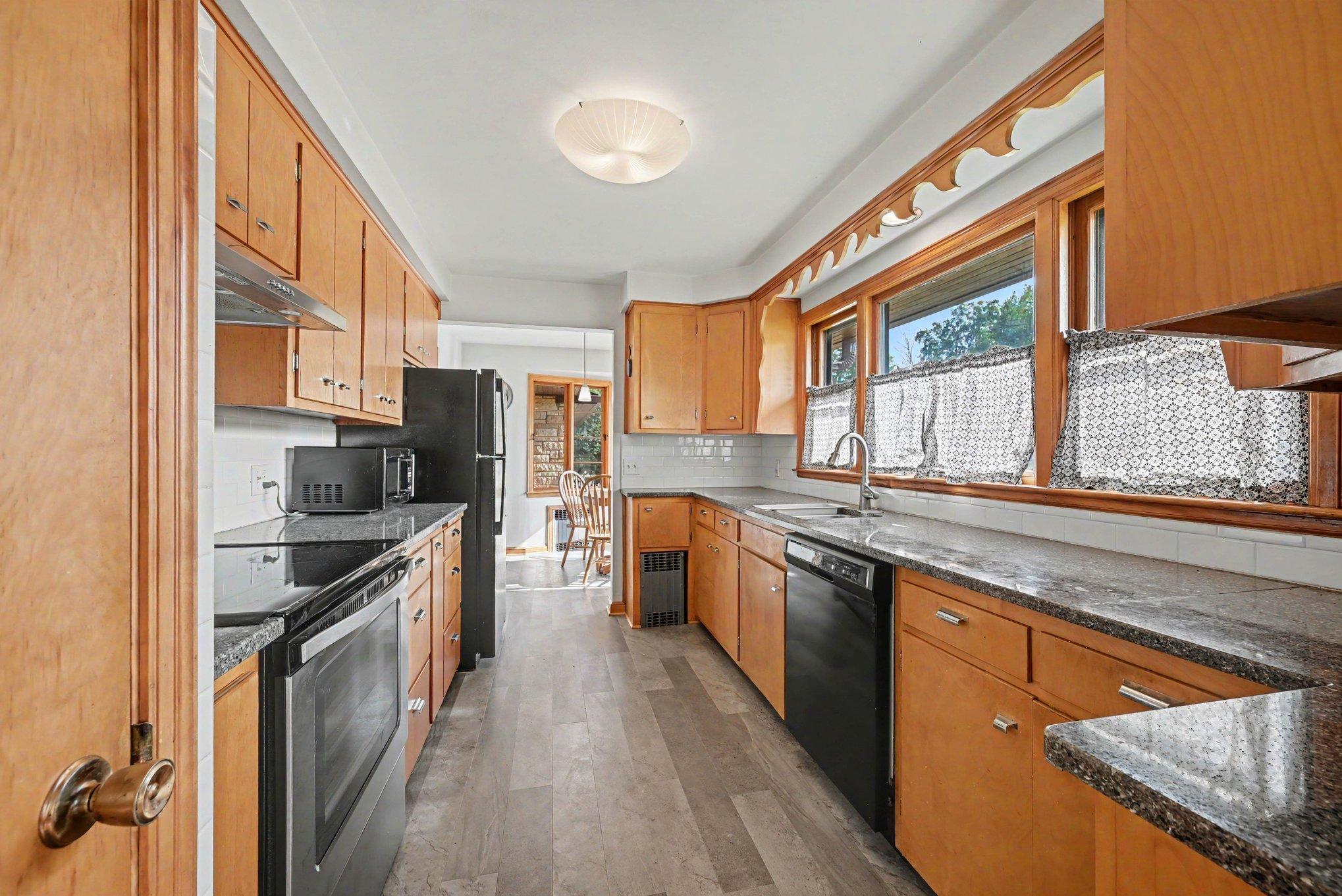 Kitchen with stainless appliances and quartz counters, Montgomery MN home for sale.