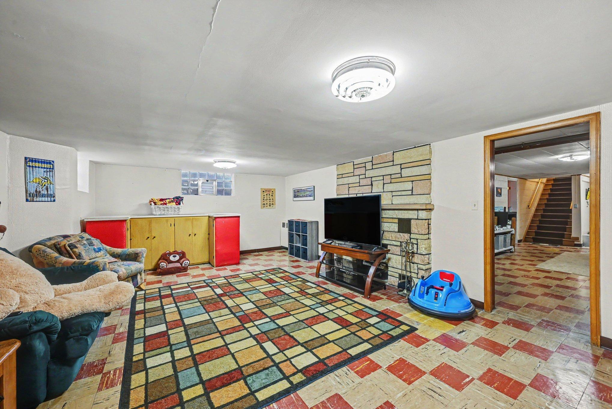 Lower level family room with wood burning fireplace, Montgomery MN rambler for sale.