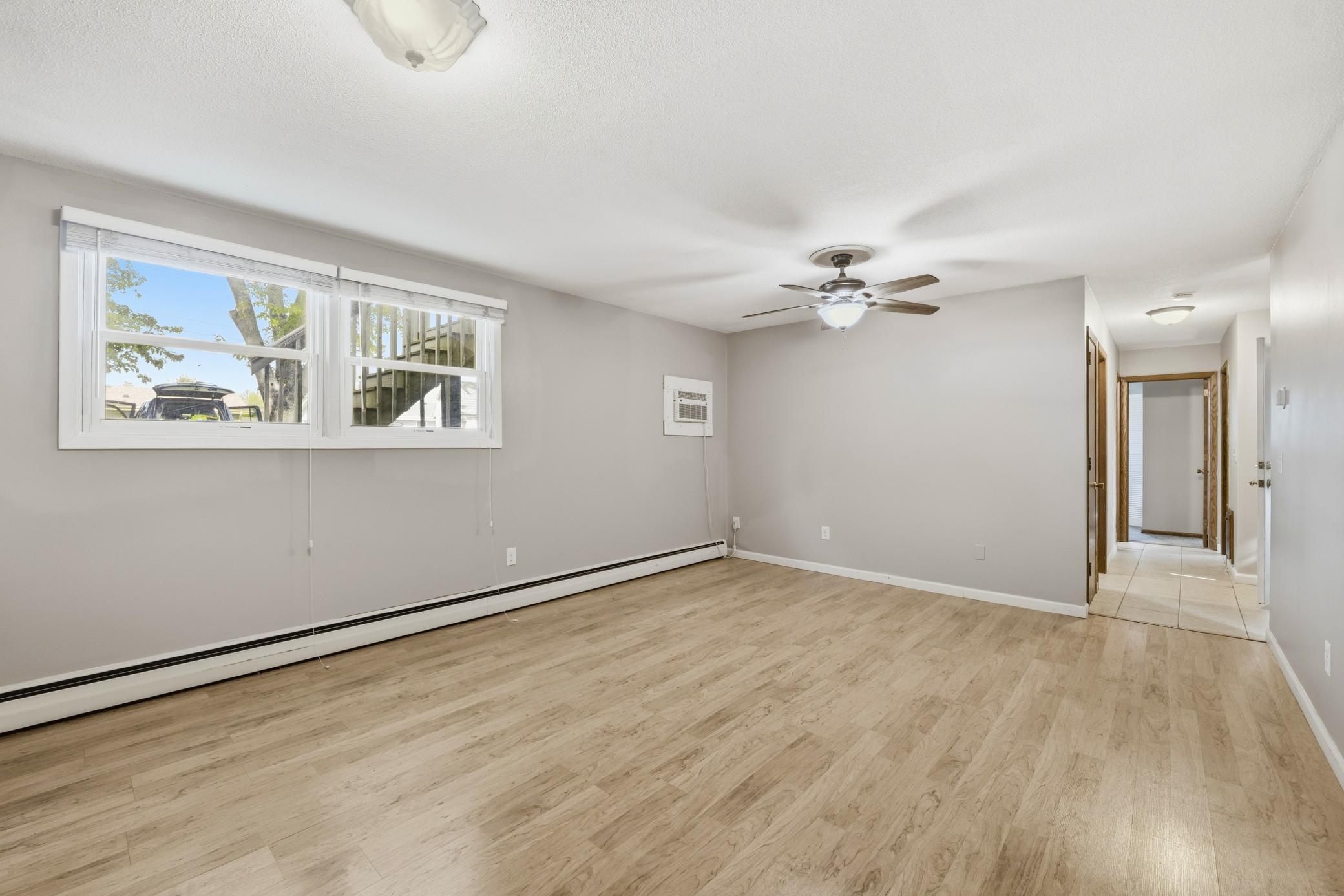Spacious family room featuring large windows that fill the space with abundant natural light, creating a bright, warm, and inviting atmosphere.