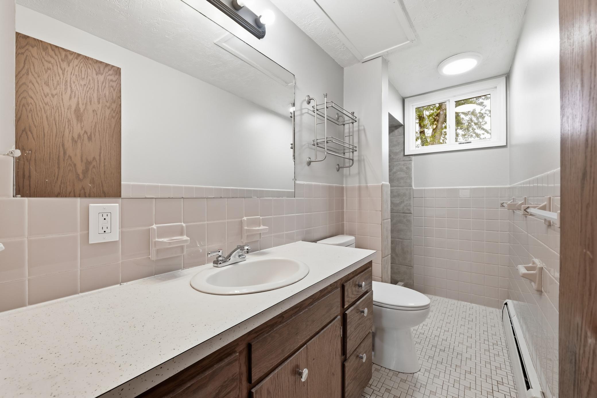 Lower-level bathroom featuring a convenient walk-in shower and a clean, functional design for everyday comfort.
