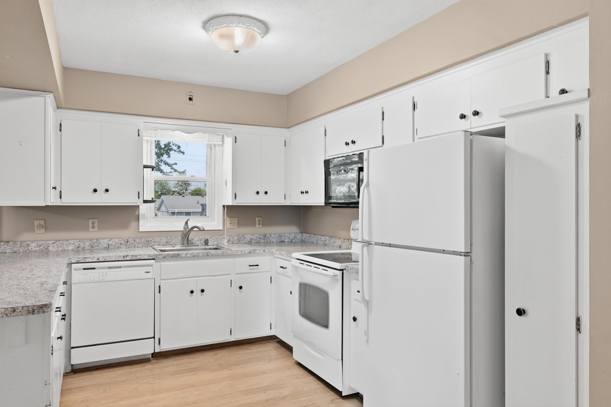Main-level kitchen featuring a window above the sink that brings in natural light and creates a bright, open, and spacious feel.