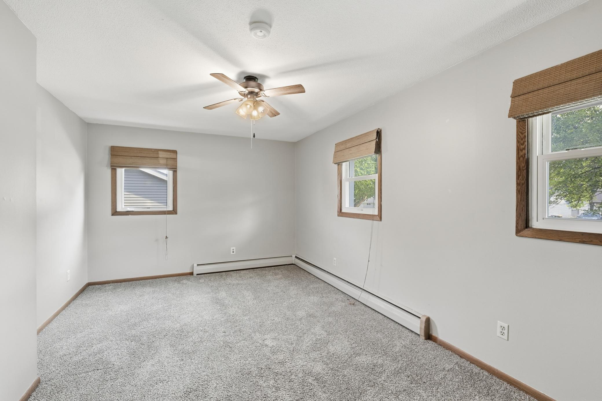 Main-level bedroom featuring windows on both sides, providing abundant natural light and a bright, comfortable feel.