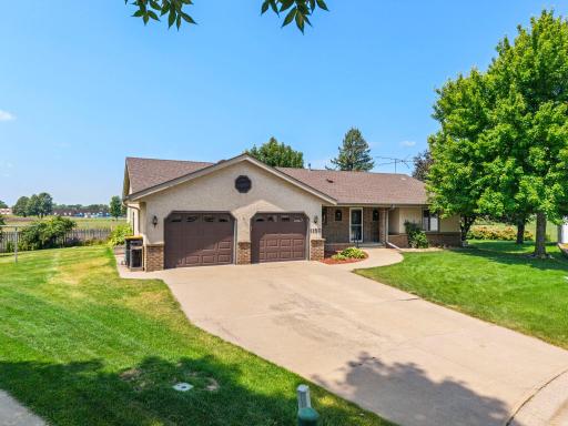 Oversized two car garage with extra parketing in large concrete driveway.