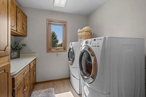 Main level laundry with built-ins! New LVP flooring spans kitchen, hallway and laundry sapce.