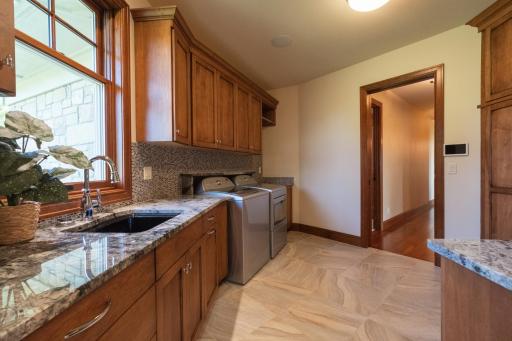 Laundry room connected to the primary suite.
